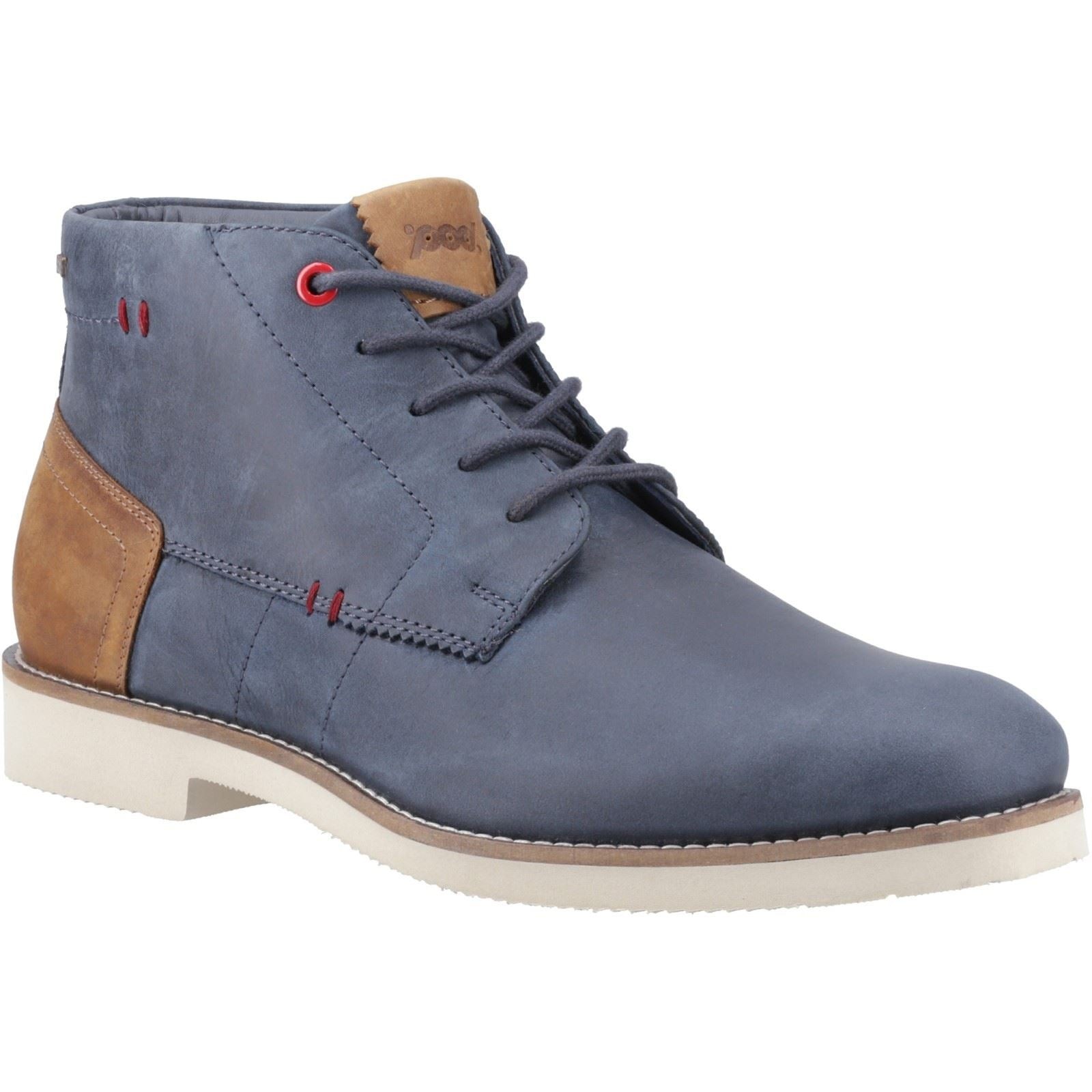 Navy leather chukka boot featuring a tan suede heel, red eyelets, and a cream rubber sole, designed for a stylish and comfortable fit.