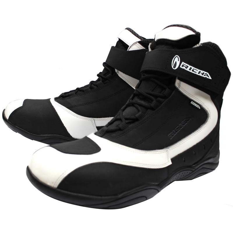 Black and white Richa Slick waterproof motorcycle boots featuring a sleek design, lace-up front, adjustable ankle strap, and reinforced toe and heel for added protection.
