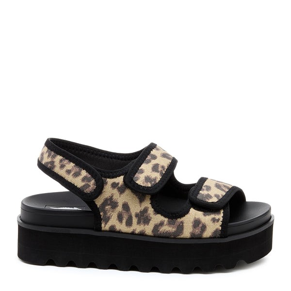 Tan and black platform sandal featuring a leopard print canvas upper, adjustable Velcro straps, and a thick black rubber sole for added comfort and style.