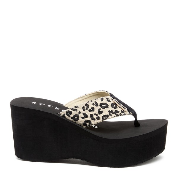 Natural-colored wedge sandal featuring a leopard print strap, a cushioned footbed, and a black platform sole for added height and comfort.
