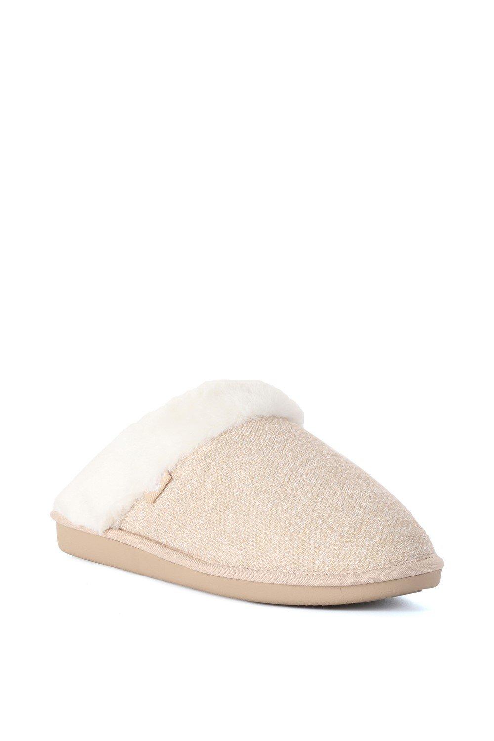 Beige fabric slippers with a soft, white faux fur lining and a flat, rubber sole, featuring a textured woven design on the upper.