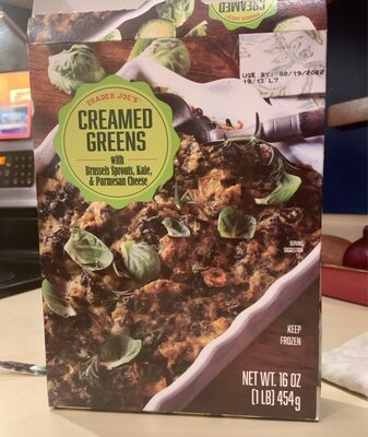 Green and white box of "Creamed Greens" featuring Brussels sprouts, kale, and Parmesan cheese, with a serving suggestion on a white dish, labeled 16 oz, and marked "keep frozen."