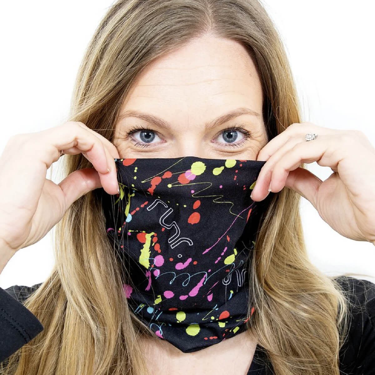 Black RUNR Snood featuring a vibrant splatter design in pink, yellow, and green, worn around the neck by a model with long hair, showcasing its stretchy, versatile material.