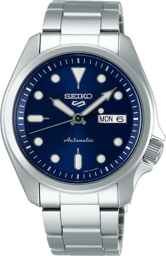 Seiko 5 SRPE53K features a stainless steel case and bracelet, a blue dial with luminous hour markers, silver hands, and a day-date display at 3 o'clock.