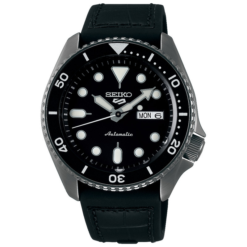 Seiko 5 Sports SRPD65K3 features a black dial with luminous markers, stainless steel case, rotating bezel, and a black rubber strap, showcasing an automatic movement with day-date display.