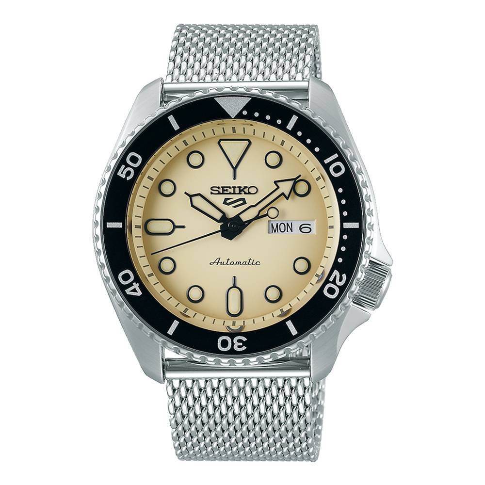 Seiko 5 Sports SRPD67K1 men's automatic watch featuring a 42.5mm beige dial, black bezel, luminous markers, day-date display, and a silver mesh bracelet.