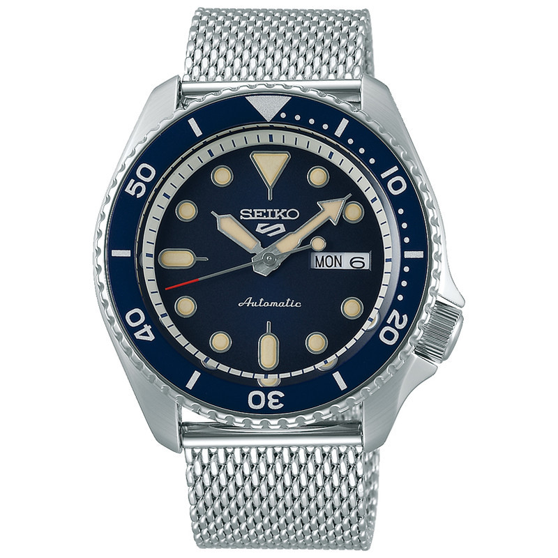Seiko 5 Sports SRPD71K1 men's automatic watch features a 42.5mm stainless steel case, blue dial with gold-tone markers, and a mesh bracelet.