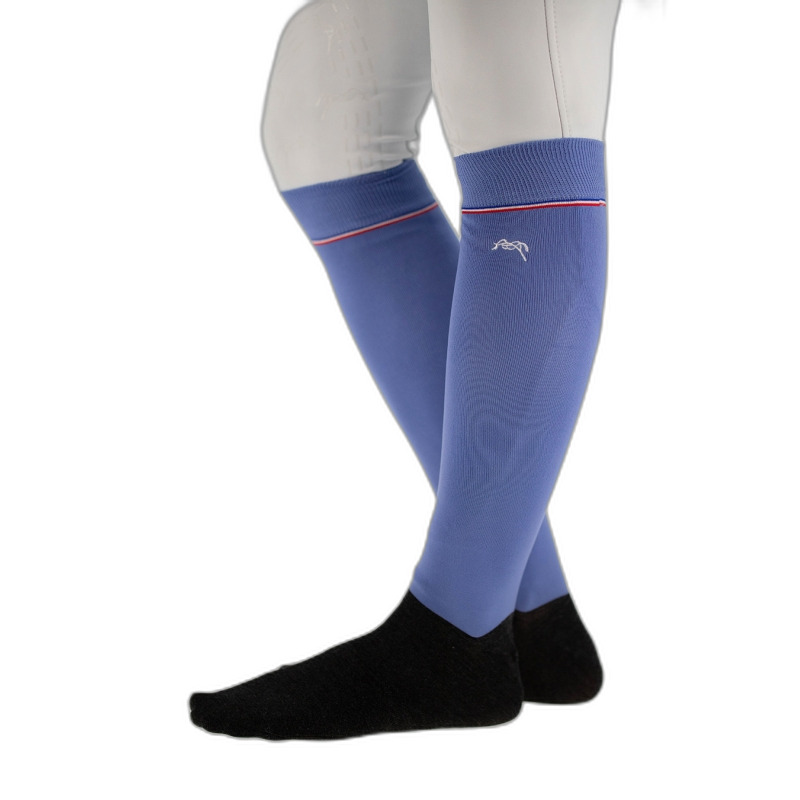 Luxury riding socks in soft blue with contrasting black foot section, featuring a stylish red stripe at the top and a subtle logo, designed for comfort and performance.
