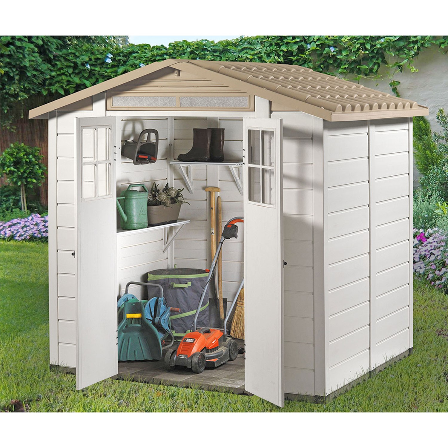 White PVC garden shed with a brown apex roof, double doors, and shelves inside, showcasing gardening tools and equipment in a vibrant garden setting.