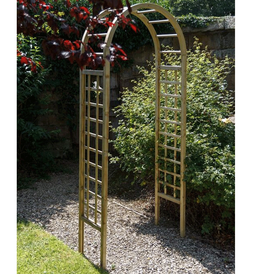 Brown wooden garden arch with a trellis design, featuring an arched top and vertical slats, set against a lush green backdrop.
