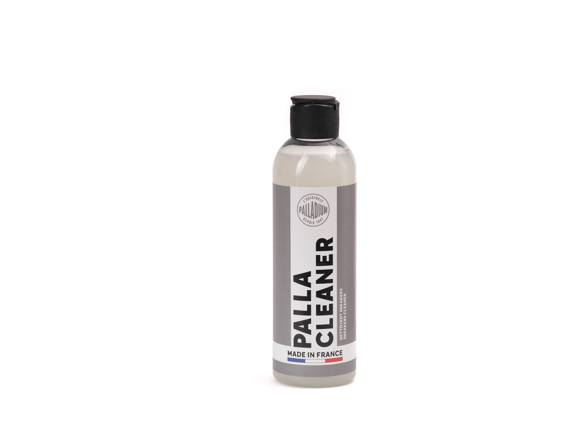 Clear bottle of Palladium Clean shoe cleaner, featuring a gray label with bold black text, a black cap, and the phrase "Made in France" at the bottom.