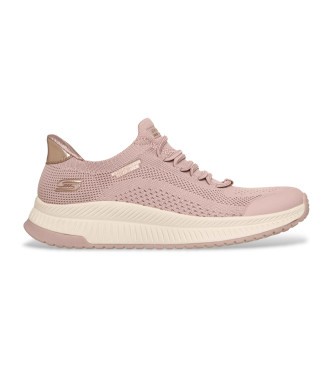 Light pink slip-on sneakers with a breathable mesh upper, featuring a textured design, lace-up front, and a cushioned sole for casual and athletic wear.
