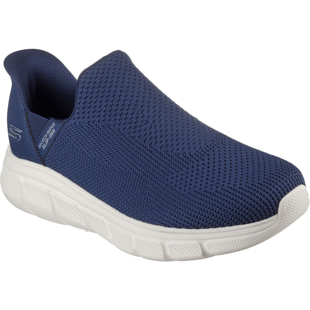 Navy slip-on trainers with a breathable mesh upper, cushioned sole, and flexible design, featuring Skechers branding and a size of 6.
