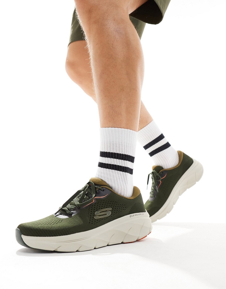 Skechers Men's D'Lux Walker 2.0 Trainers feature an olive green mesh upper, orange accents, a cushioned sole, and are paired with white socks and shorts.