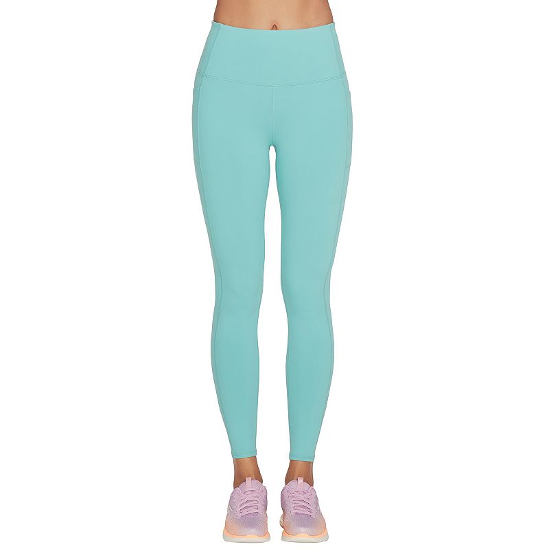 Turquoise high-waisted leggings made from stretchy material, featuring a sleek design, paired with light pink athletic shoes for a sporty look.