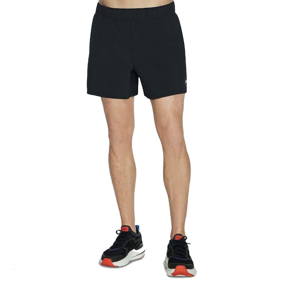 Black Skechers Men Razor Shorts in size Medium, featuring an elastic waistband and lightweight material, paired with athletic shoes for a sporty look.