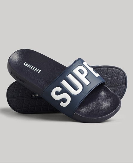 Navy blue slides featuring a wide strap with "SUPER" printed in bold white letters, made from a durable material with a textured sole for grip.