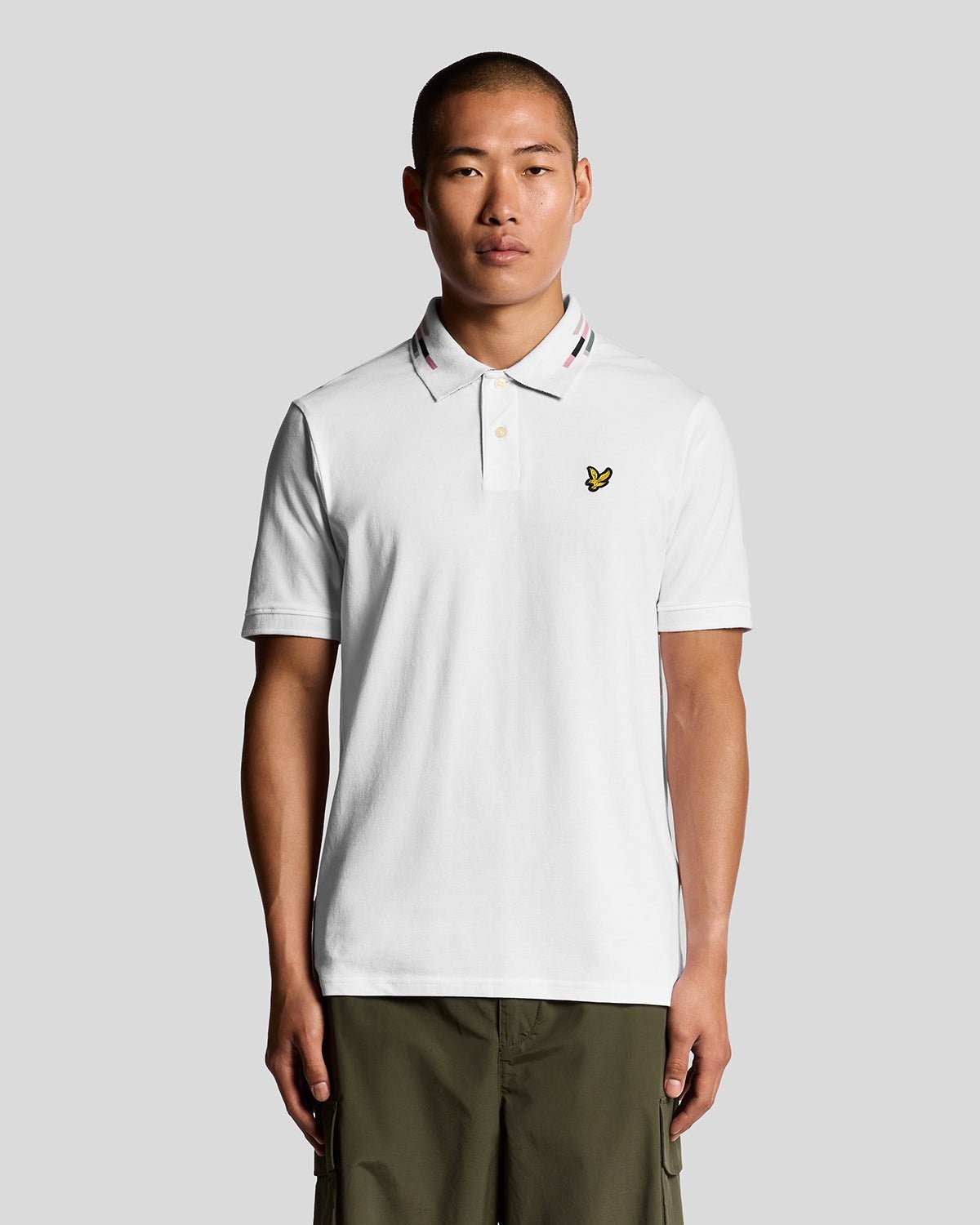 White striped polo shirt with piping details, featuring a classic collar and a small yellow Lyle & Scott logo on the chest, made from breathable cotton material.
