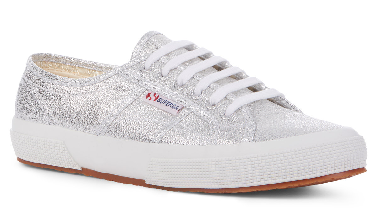 Grey silver trainers with a metallic finish, featuring white laces, a white rubber sole, and a red Superga logo on the side.