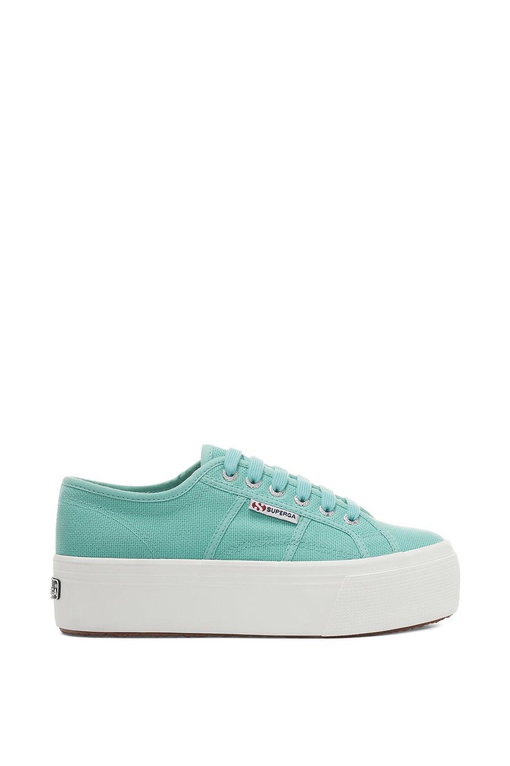 Green water canvas trainers with a thick white sole, featuring a lace-up design and Superga logo on the side.