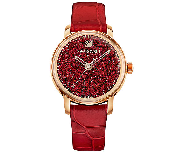 Swarovski 5295380 Crystalline women's watch features a red crystal dial, gold-tone case, and a red leather strap, showcasing elegance and sparkle.