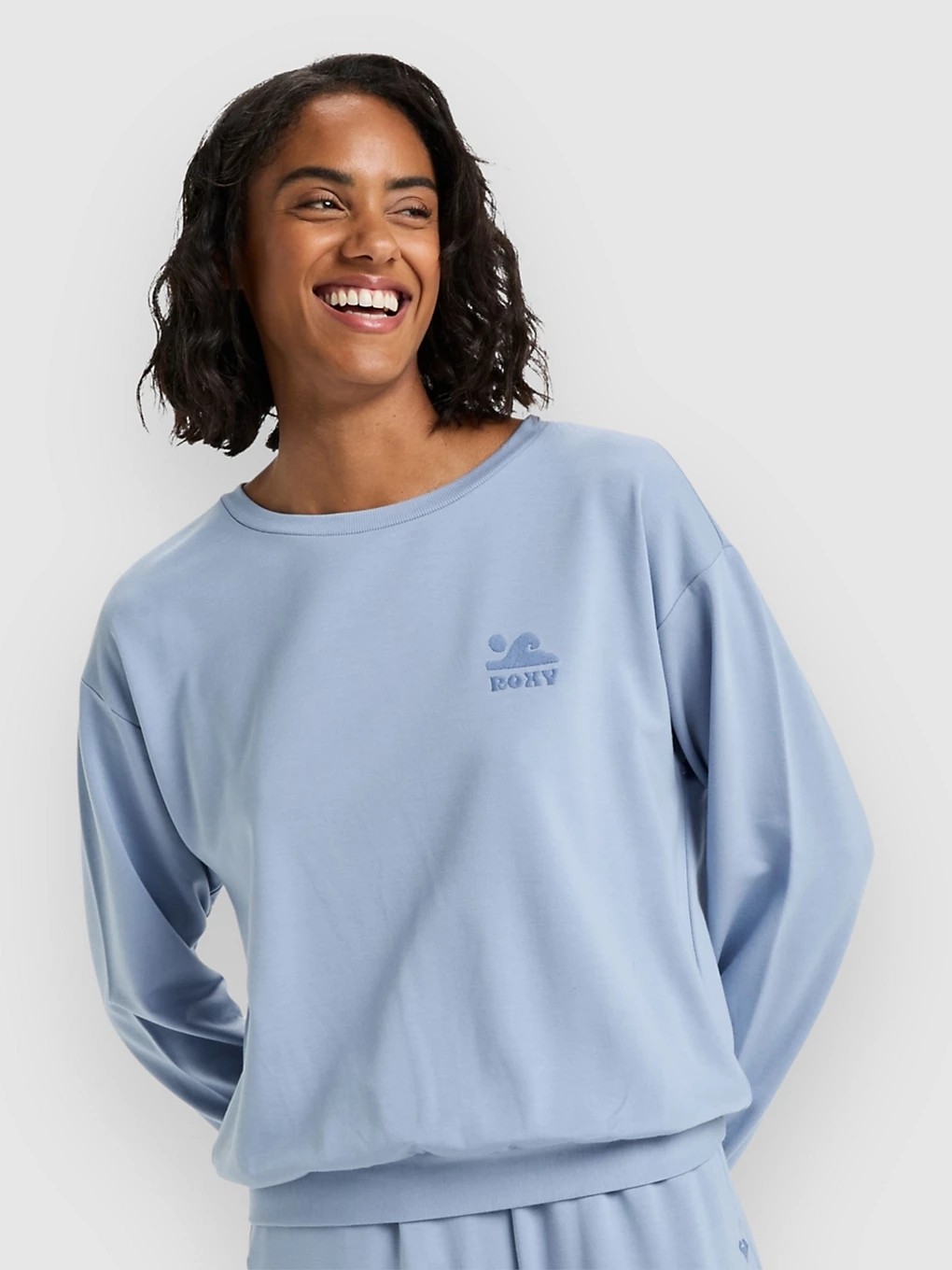 Light blue sweatshirt featuring a relaxed fit, round neckline, and the Roxy logo in a darker shade on the chest, made from soft, comfortable material.