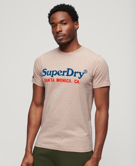 Light brown short-sleeve T-shirt featuring a blue and red Superdry logo with "SANTA MONICA. CA." text, made from soft cotton material.