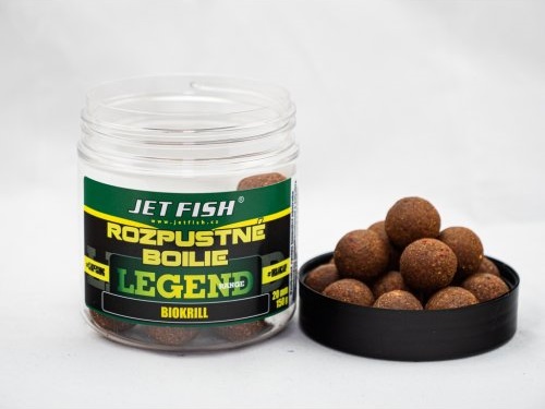 Clear plastic jar containing round, brown fishing boilies labeled "Jet Fish Rozpustn Boilie Legend Range" with "Chilli Tuna Chilli" flavor, alongside a black lid and some boilies spilled out.
