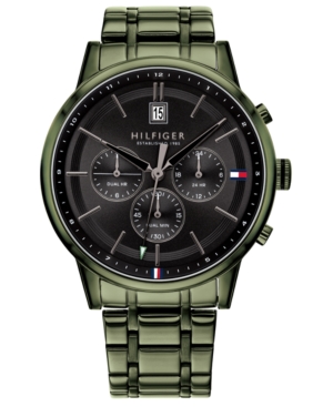 Black dial chronograph men's watch by Tommy Hilfiger features a sleek green metal bracelet, three sub-dials, date display, and signature logo accents in red, white, and blue.