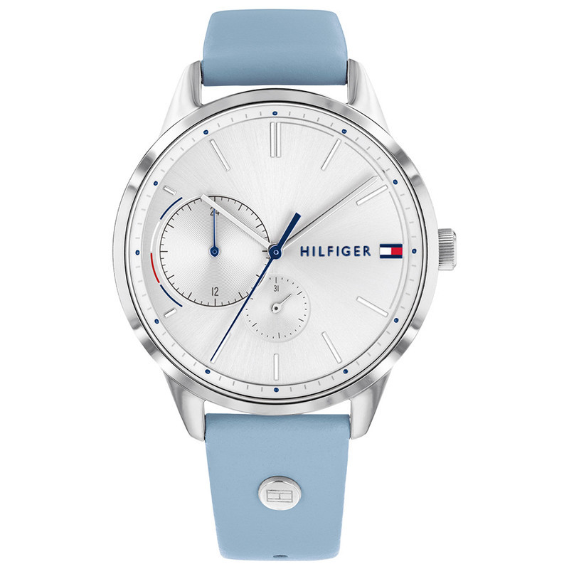 Silver dial women's watch with a 38mm case, featuring a blue leather strap, minimalist design, and two sub-dials, accented by the Tommy Hilfiger logo.
