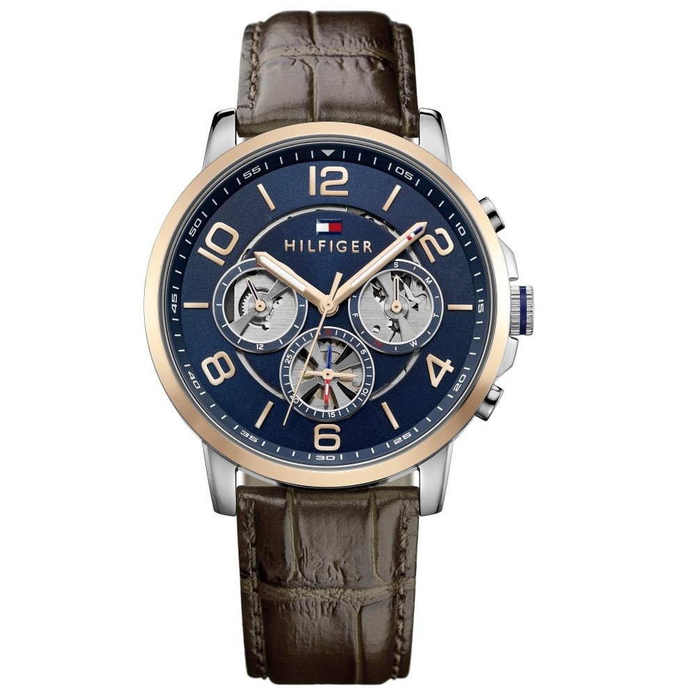 Men's Tommy Hilfiger Keagan watch features a 44mm navy dial with silver-tone hands, three subdials, and a brown leather strap with a crocodile texture.