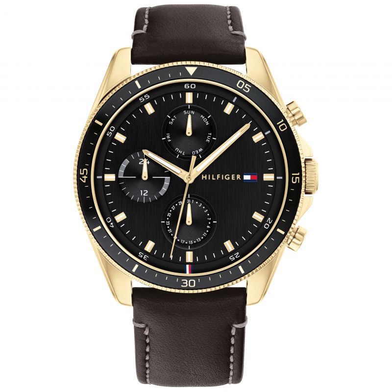 Men's Tommy Hilfiger Parker watch features a 44mm black dial with gold-tone accents, multifunction sub-dials, and a brown leather strap.