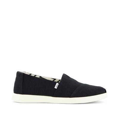 Black canvas slip-on shoes with a textured finish, featuring a white rubber sole and a subtle TOMS logo on the side, designed for comfort and casual wear.