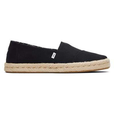 Black 100% cotton espadrilles with a slip-on design, featuring a jute rope sole and a small TOMS logo tag on the side.