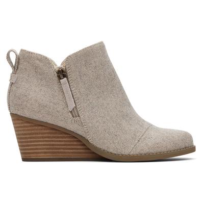Beige wedge boot with a textured fabric upper, featuring a side zipper and a stacked wooden heel, designed for a stylish and comfortable fit.