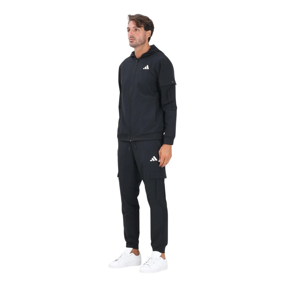 Black Adidas tracksuit featuring a zip-up hoodie and cargo pocket pants, made from a lightweight material, with the iconic white Adidas logo on the chest and side.