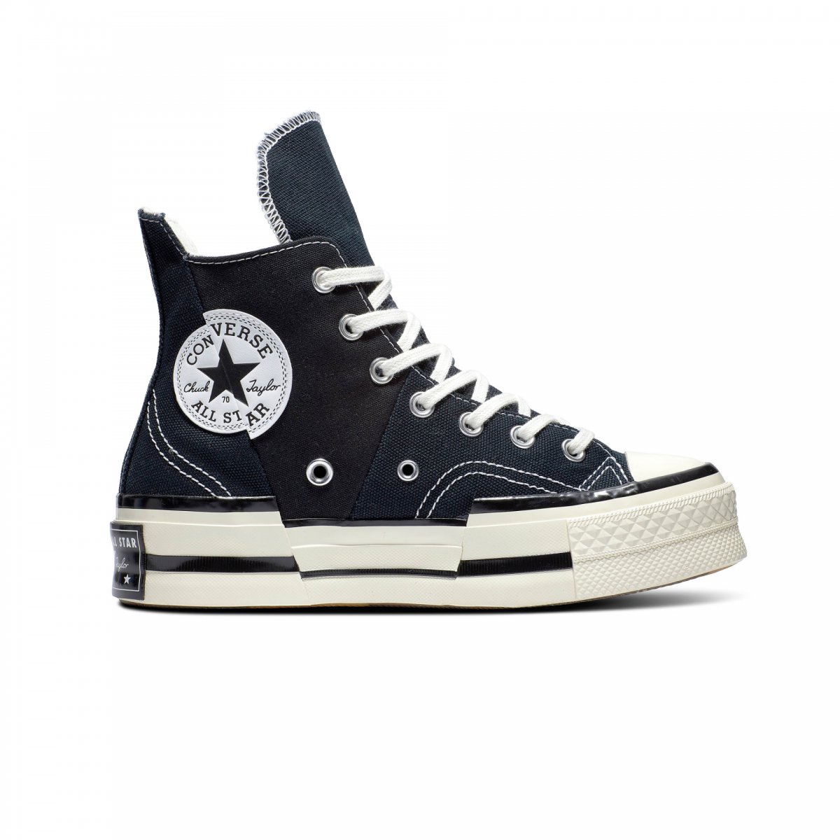 High-top navy canvas trainers featuring a white rubber sole, iconic Chuck Taylor patch, and contrasting stitching details.