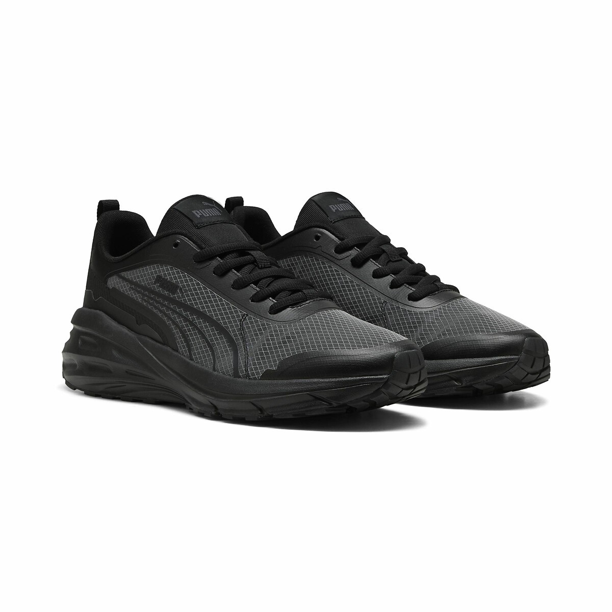 Black and grey Puma Hypnotic Tech Trainers featuring a mesh upper, cushioned sole, and signature logo on the tongue, designed for comfort and style.