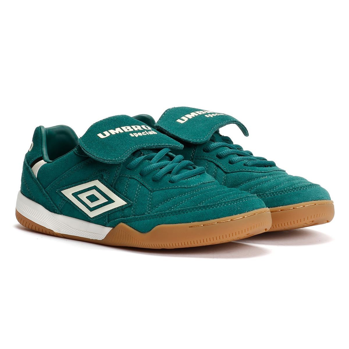 Forest green suede trainers with antique white accents, featuring a Velcro strap, signature Umbro logo, and a gum rubber sole.