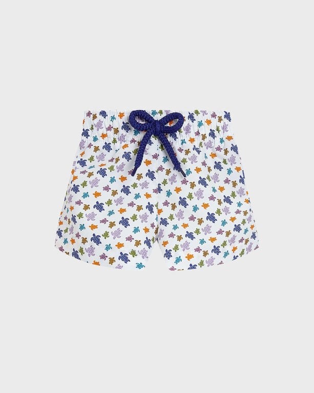 White baby swim shorts featuring a colorful turtle print, elastic waistband with a navy blue drawstring, made from lightweight material, designed for size 12M.