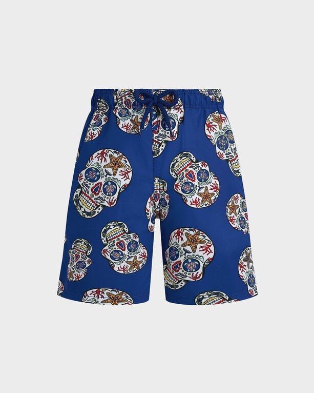 Boys' blue stretch swim shorts featuring a Día De Muertos skull print, with colorful designs and an elastic waistband with a drawstring, size 4.