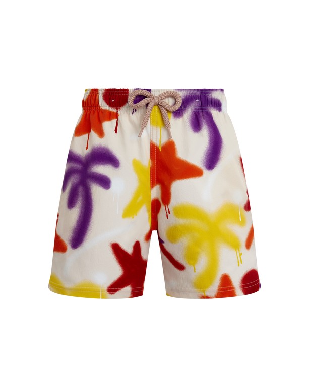Boys' pink stretch swim shorts featuring a vibrant spray paint design with palm trees in red, yellow, and purple, finished with an elastic waistband and drawstring.