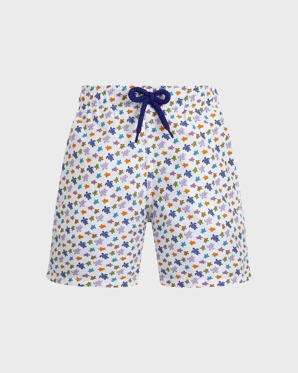 Boys' white swim shorts featuring a colorful turtle print, elastic waistband with a navy drawstring, made from lightweight material, size 8.