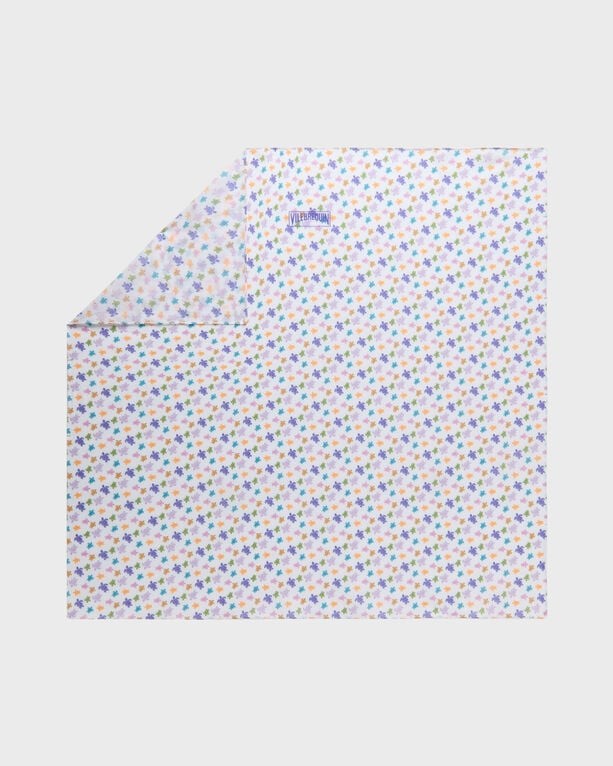 White cotton voile scarf featuring a colorful micro turtle print, with a logo in the corner, designed for versatile styling. Size OSFA.
