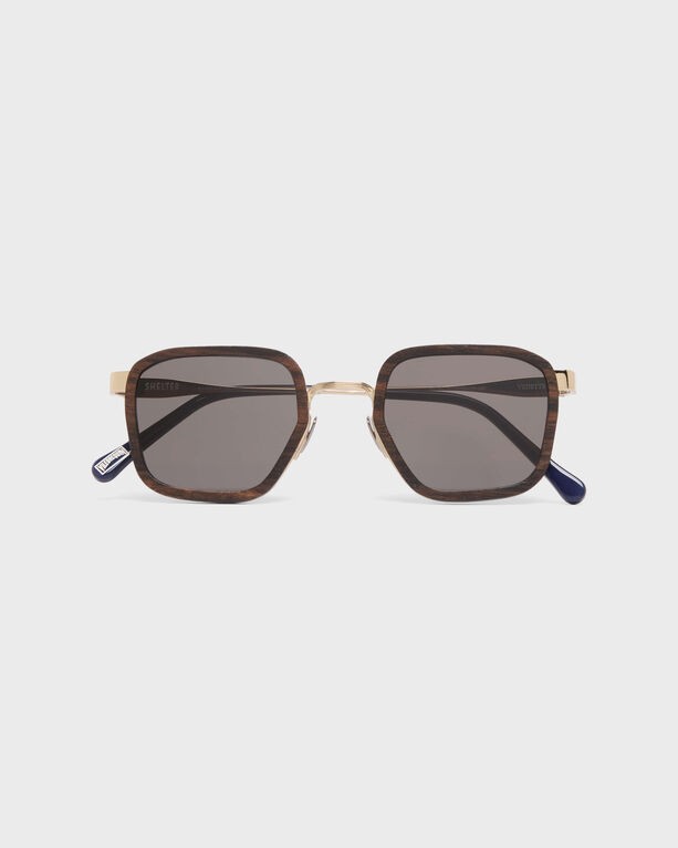 Ebonywood sunglasses featuring a square frame with a brown tortoiseshell pattern, gray lenses, and gold accents, complemented by blue temple tips.