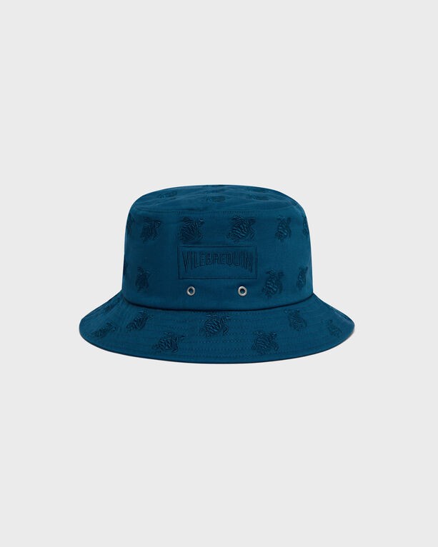 Blue embroidered bucket hat featuring turtle motifs, made from soft material with a wide brim and ventilation eyelets, labeled with "Vilebrequin" on the front. Size XS/S.