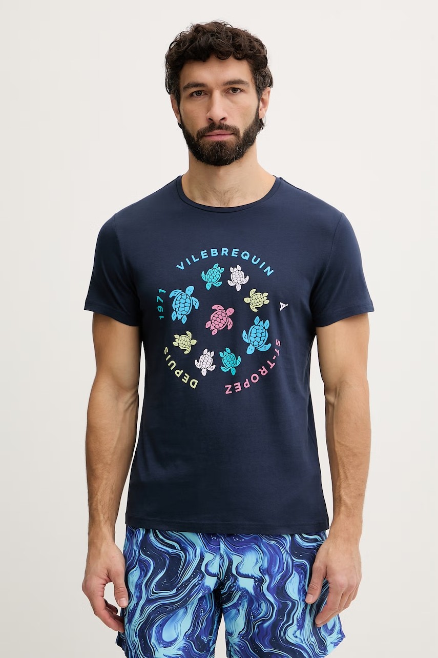 Navy blue cotton T-shirt featuring colorful turtle graphics in a circular pattern, with "Vilebrequin" and "1971" text, paired with blue marbled swim shorts.