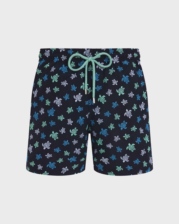 Blue swim shorts featuring a vibrant turtle embroidery pattern in green and white, with an elastic waistband and drawstring, made from lightweight material.