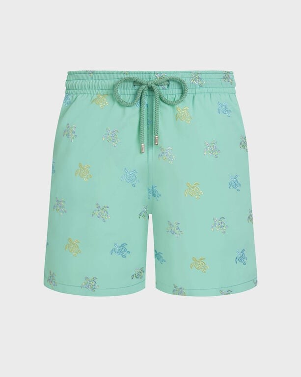 Green embroidered swim shorts featuring a playful turtle pattern in various colors, with an elastic waistband and drawstring, made from lightweight material. Size S.