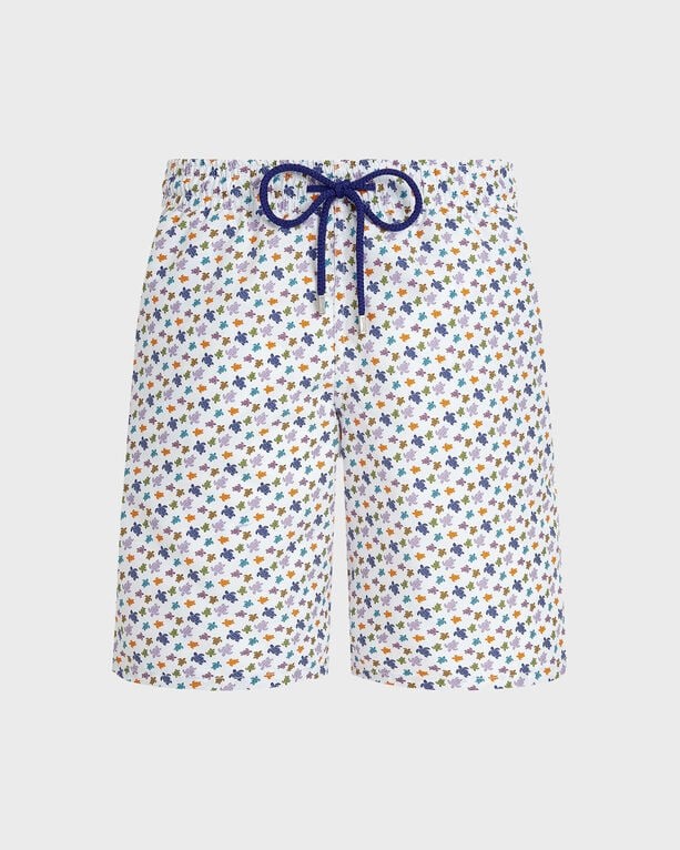 White swim shorts featuring a colorful turtle print, elastic waistband with a navy drawstring, and a lightweight material ideal for beachwear, in size S.